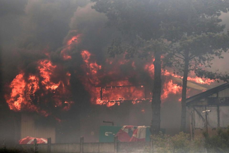 A fire burns a building in an industrial area during the forest fires affecting Vina del Mar, Valparaiso Region (EPA)