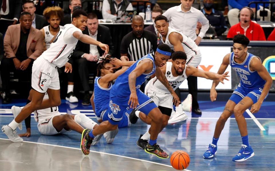 Cincinnati and Memphis players battle for control of the ball during the second half of a game Sunday, Jan. 9, at FedExForum. The Memphis Tigers defeated the Cincinnati Bearcats 87-80. 