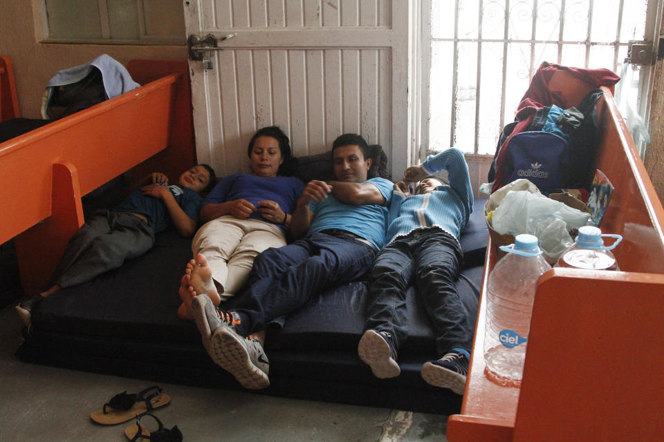 In this June 10, 2019, photo, Mirna Esperanza Martinez, from El Salvador, rests with family members at the Buen Pastor migrant shelter in Ciudad Juarez, Mexico. They are subject to a new policy that makes asylum seekers wait in Mexico while their asylum cases wind through U.S. immigration court. (AP Photo/Cedar Attanasio)