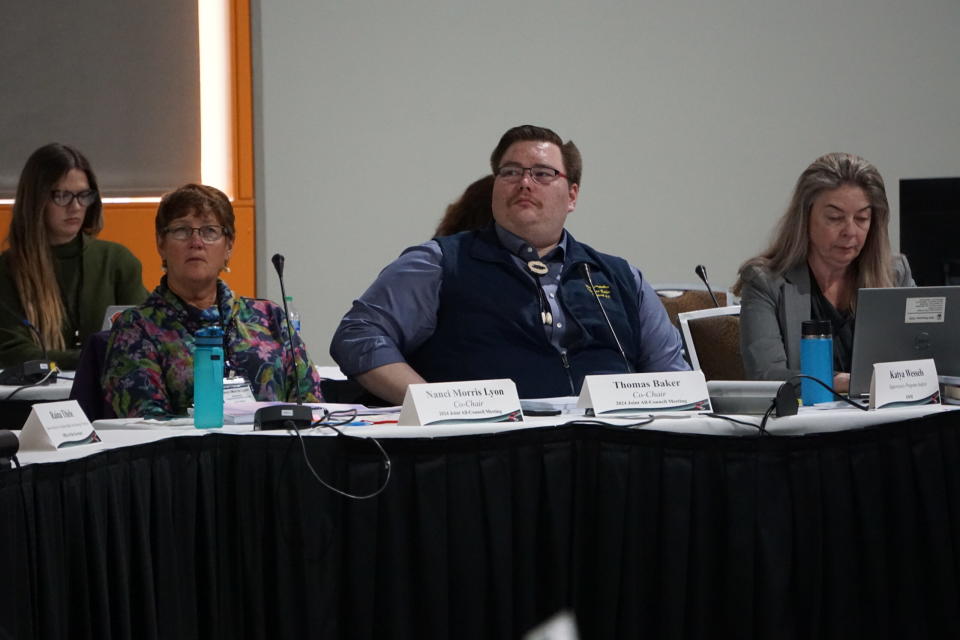 Nanci Morris Lyon, from Dillingham, and Thomas Baker, from Kotzebue, listen on March 5, 2024, to comments from regional representatives about commercial fishery conflicts with subsistence resources. Morris Lyon and Baker are co-chairs of the 2024 All-Council meeting of the state's 10 ten subsistence regional advisory councils. The meeting is being held at Anchorage's Dena'ina Civic and Convention Center. (Photo by Yereth Rosen/Alaska Beacon)