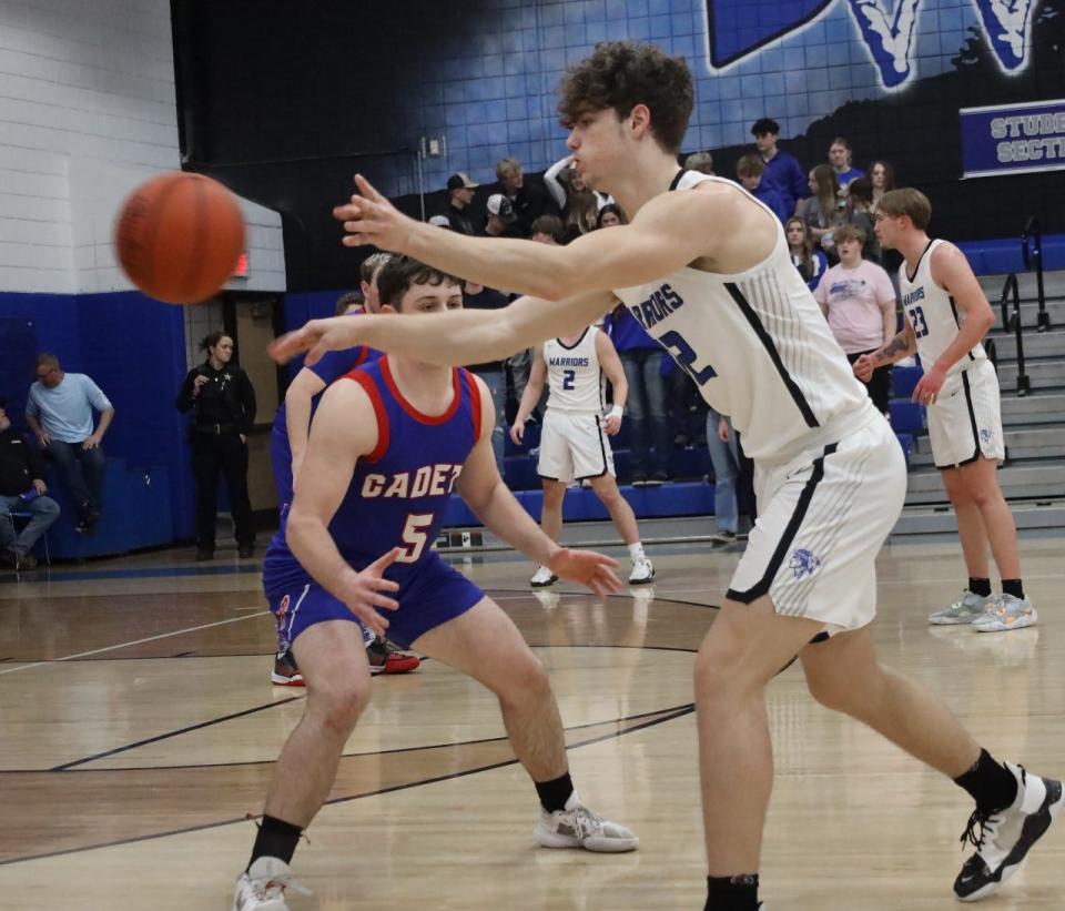 Buckeye Trail junior Brady Hastings (12) passes to a teammate with Fort Frye's Zaiden Huck (5) applying defensive pressure during OVAC action in Old Washington on Friday evening.