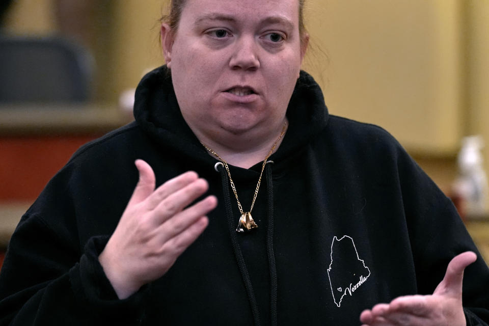 Megan Vozzella, who is deaf, signs while describing future concerns following a visit by Steven Dettelbach, the Director of the Bureau of Alcohol, Tobacco and Firearms, with community members that were personally effected by the October 2023 mass shootings in Lewiston, Maine at Central Maine Community College, Thursday, Feb. 22, 2024, in Auburn, Maine. Vozzella's husband Steve, who also was deaf, was killed in the shootings. Four of the 18 victims of the Maine shootings were deaf. (AP Photo/Charles Krupa)