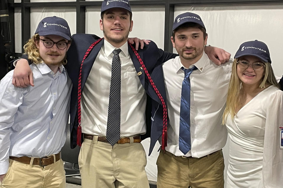 Students, from left, James Holt, Will Gower, Nicholas Colasacco, and Savannah Gibson, all 21, pose for a photo in Hagerstown, Maryland on Tuesday, April 25, at graduation from the Pittsburgh Institute of Aeronautics. Students graduating from PIA have been awed by how much they're in demand. Recruiters are desperately seeking more aircraft mechanics for the airlines, airplane manufacturers, and repair shops that need them. (AP Photo/Chris Rugaber)