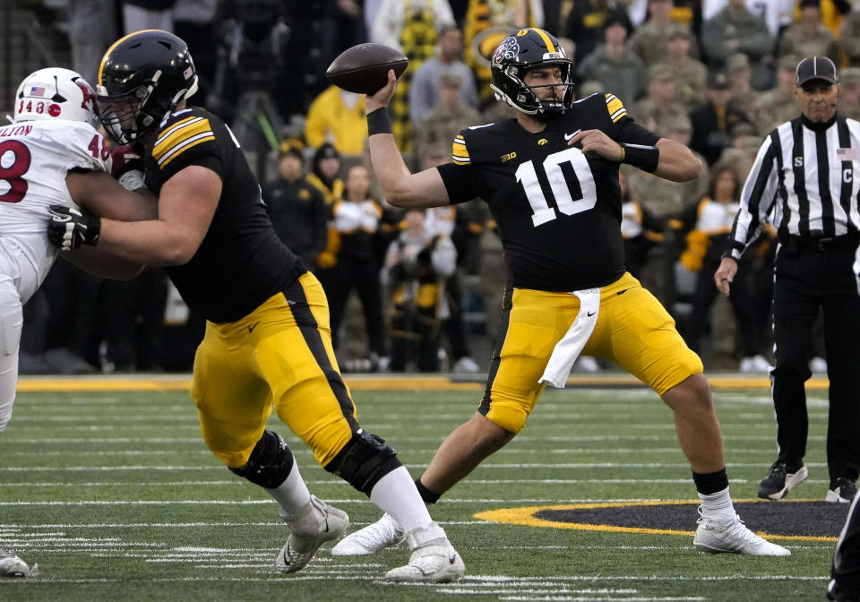 Iowa quareterback Deacon Hill (10) looks to throw a pass against Rutgers during the first half of an NCAA college football game, Saturday, Nov. 11, 2023, in Iowa City, Iowa. (AP Photo/Bryon Houlgrave)