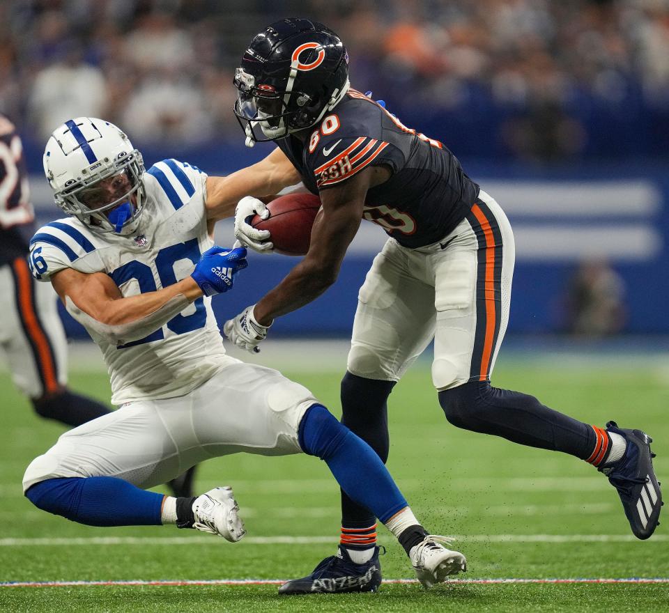 Chicago Bears wide receiver Joe Reed (80) tries to hold onto the ball as he is hit by Indianapolis Colts running back Evan Hull (26) during the second half of an NFL preseason game Saturday, Aug. 19, 2023, at Lucas Oil Stadium in Indianapolis.