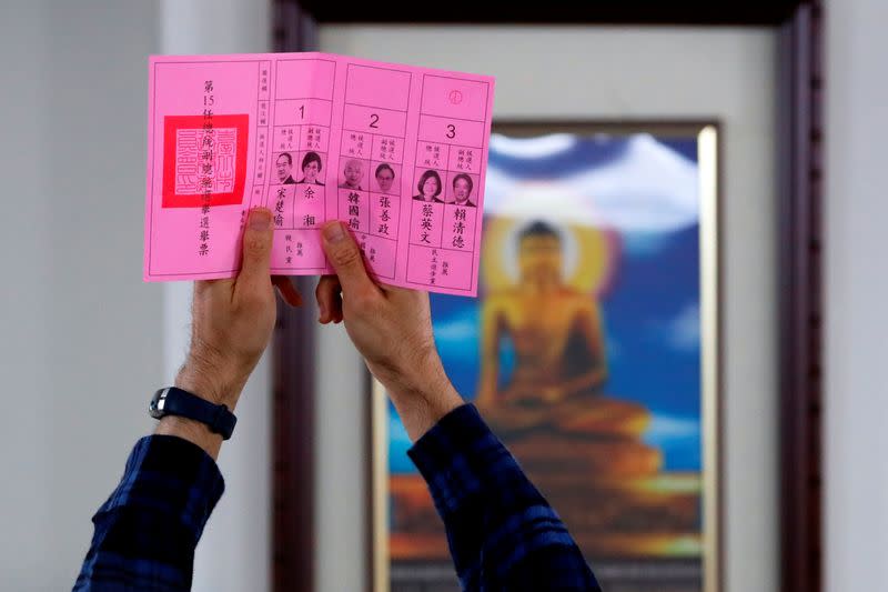 An election official shows a ballot with vote for Taiwan President Tsai Ing-wen as votes are counted at a polling station in Taipei