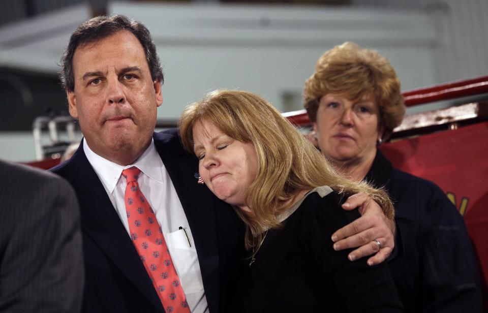 New Jersey Gov. Chris Christie hugs Amy Peters, of Manahawkin, Thursday, Jan. 16, 2014, in Manahawkin, N.J., as he meets with homeowners who lost their homes last year to Superstorm Sandy. Christie spoke to Superstorm Sandy victims one week after the meeting was hastily canceled because of a scandal over traffic jams that appear to have been manufactured by his aides. Christie and Community Affairs Commissioner Richard Constable III announced a Sandy housing recovery milestone Thursday as the governor seeks to put the traffic scandal behind him. (AP Photo/Mel Evans)