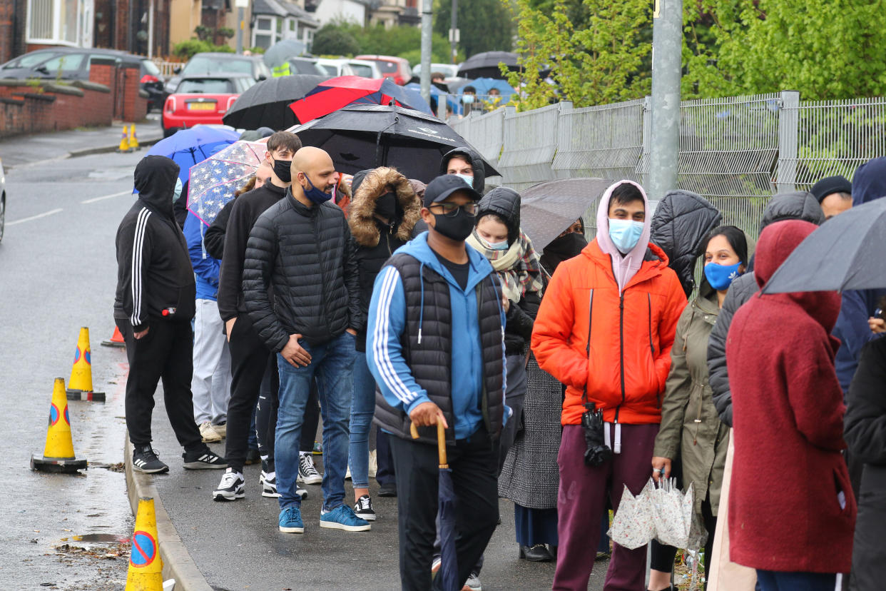 People could be seen braving the weather to queue through the streets.