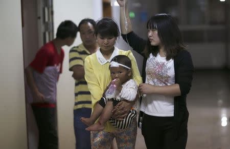 A child drinks milk from a bottle at a hospital after being injured in an earthquake in Ludian county of Zhaotong, Yunnan province August 3, 2014. REUTERS/Wong Campion