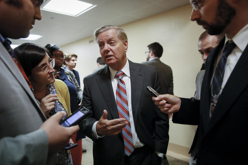 Senate Judiciary Committee Chairman Lindsey Graham, R-S.C., talks to reporters on his way to the Senate chamber for votes on federal judges as a massive budget pact between House Speaker Nancy Pelosi and President Donald Trump is facing a key vote in the GOP-held Senate later, at the Capitol in Washington, Wednesday, July 31, 2019. (AP Photo/J. Scott Applewhite)