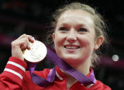 Canada's Rosannagh Maclennan displays her gold medal during the podium ceremony of the women's trampoline at the 2012 Summer Olympics, Saturday, Aug. 4, 2012, in London. (AP Photo/Gregory Bull)