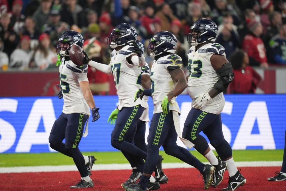 Seattle Seahawks’ Tariq Woolen (27) reacts after an interception during the second half of an NFL football game against the Tampa Bay Buccaneers, Sunday, Nov. 13, 2022, in Munich, Germany. (AP Photo/Matthias Schrader)