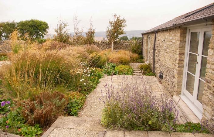 <p> Billowing borders filled with tall perennial blooms and ornamental grasses is a gorgeous sight, and will give any plot a more naturalistic edge. It&apos;s ideal for softening areas of stone, like in this garden above designed by&#xA0;Helen Elks-Smith. </p> <p> And, when it comes to wildlife garden ideas, this prairie style of planting is ideal. Not only will it attract butterflies, but birds will love it too as they forage for seeds.&#xA0; </p> <p> What&apos;s more, the mix of textures and gentle movement as the scene sways in the breeze will add a soothing sense to your space.&#xA0; </p>