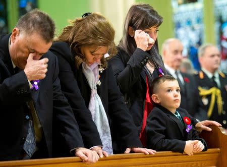 Kathy Cirillo (2nd L), Natasha Cirillo (3rd L), and Marcus Cirillo attend the regimental funeral service for her son, Cpl. Nathan Cirillo, in Hamilton, Ontario October 28, 2014. REUTERS/Nathan Denette/Pool