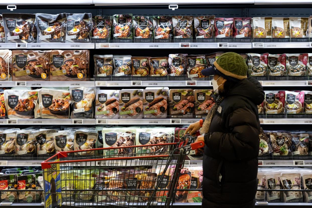 A customer pushes a cart past packaged food section at the Mega Food Market inside a Homeplus Co. store in Incheon, South Korea, on Friday, Feb. 18, 2022. (Photo: SeongJoon Cho/Bloomberg)