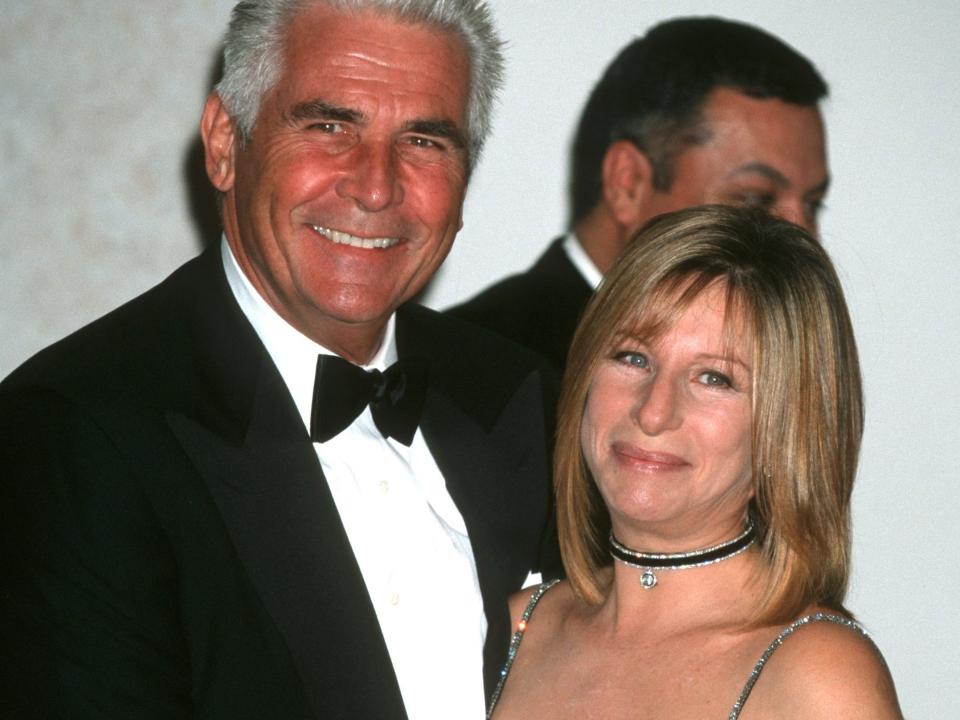 James Brolin, in a tuxedo, poses with Barbra Streisand, in a black sheer off the shoulder gown, at a 2001 event.