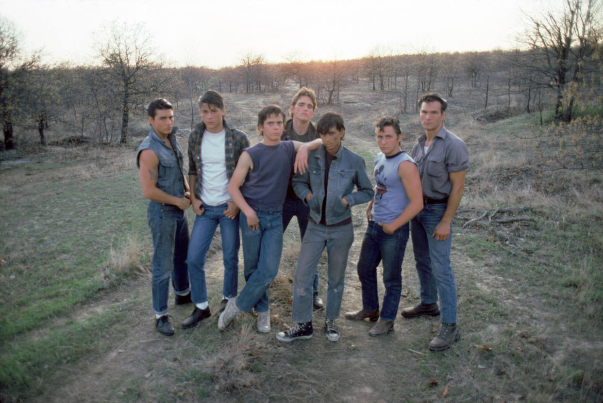 American actors Tom Cruise, Rob Lowe, Thomas C. Howell, Matt Dillon, Ralph Macchio, Emilio Estevez, and Patrick Swayze on the set of The Outsiders, directed by Francis Ford Coppola. (Photo by Sunset Boulevard/Corbis via Getty Images)