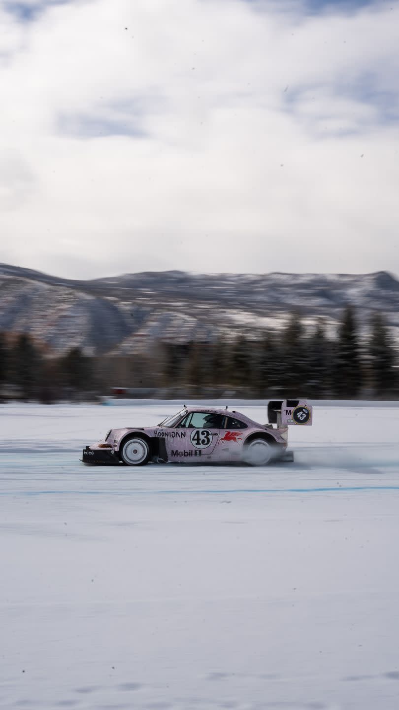 a race car driving on a snowy road