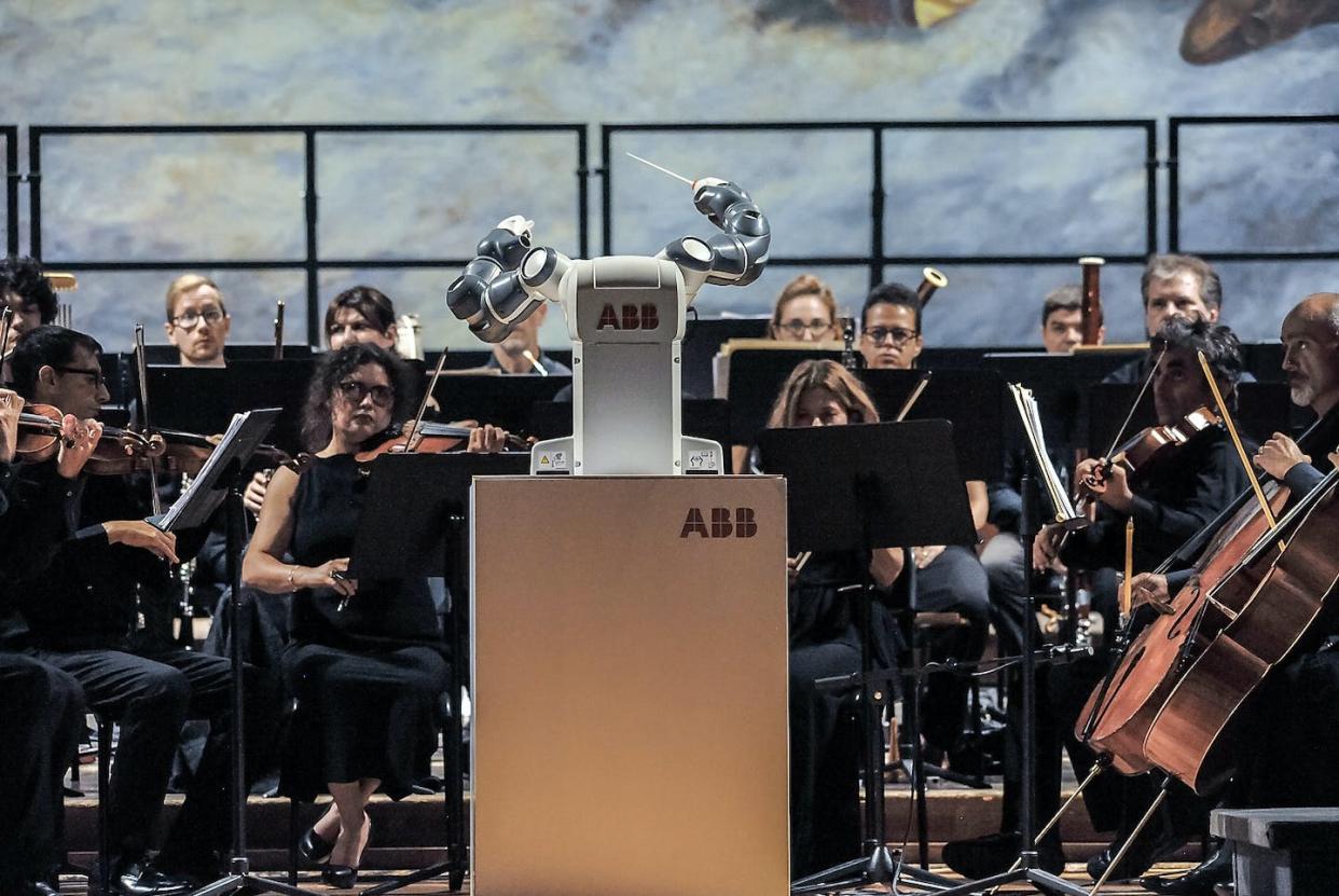 Robotic orchestra conductor 'Yumi' performs on stage with the Orchestra Filarmonica di Lucca in Italy in 2017. <a href="https://www.gettyimages.com/detail/news-photo/robotic-orchestra-conductor-yumi-performs-on-stage-with-the-news-photo/846676692?adppopup=true" rel="nofollow noopener" target="_blank" data-ylk="slk:Laura Lezza/Getty Images;elm:context_link;itc:0;sec:content-canvas" class="link ">Laura Lezza/Getty Images</a>