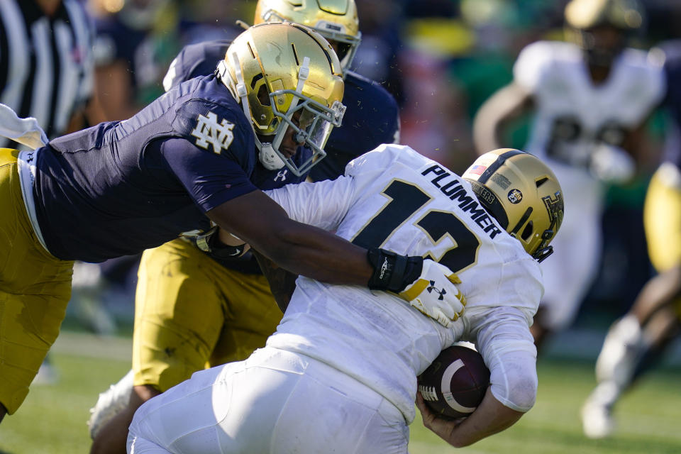 Notre Dame defensive lineman Justin Ademilola (9) sacks Purdue quarterback Jack Plummer (13) during the second half of an NCAA college football game in South Bend, Ind., Saturday, Sept. 18, 2021. Notre Dame defeated Purdue 27-13. (AP Photo/Michael Conroy)