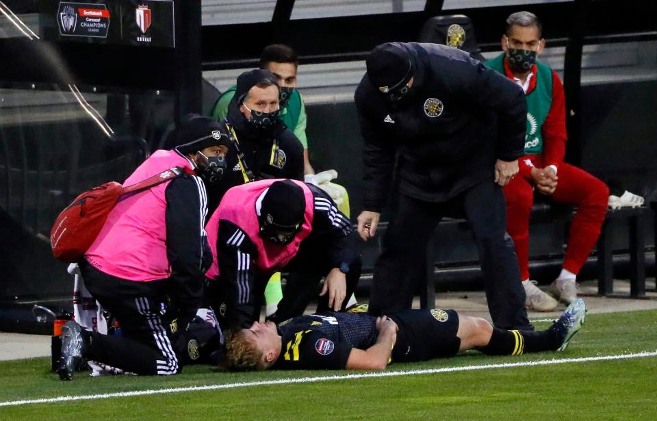 Columbus Crew SC midfielder Aidan Morris (21) receives medical treatment on his left knee after a non-contact injury against Real Estel’ FC during the first half of their CONCACAF Champions League quarterfinals game at Crew Stadium on April 15, 2021. 