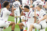 Bologna's Joshua Zirkzee, right, celebrates with his teammates Alexis Saelemaekers, right, and Dan Ndoyeafter scoring the second goal against Roma during the Italian Serie A soccer match between Roma and Bologna at Rome's Olympic Stadium, Monday, April 22, 2024. (AP Photo/Gregorio Borgia)