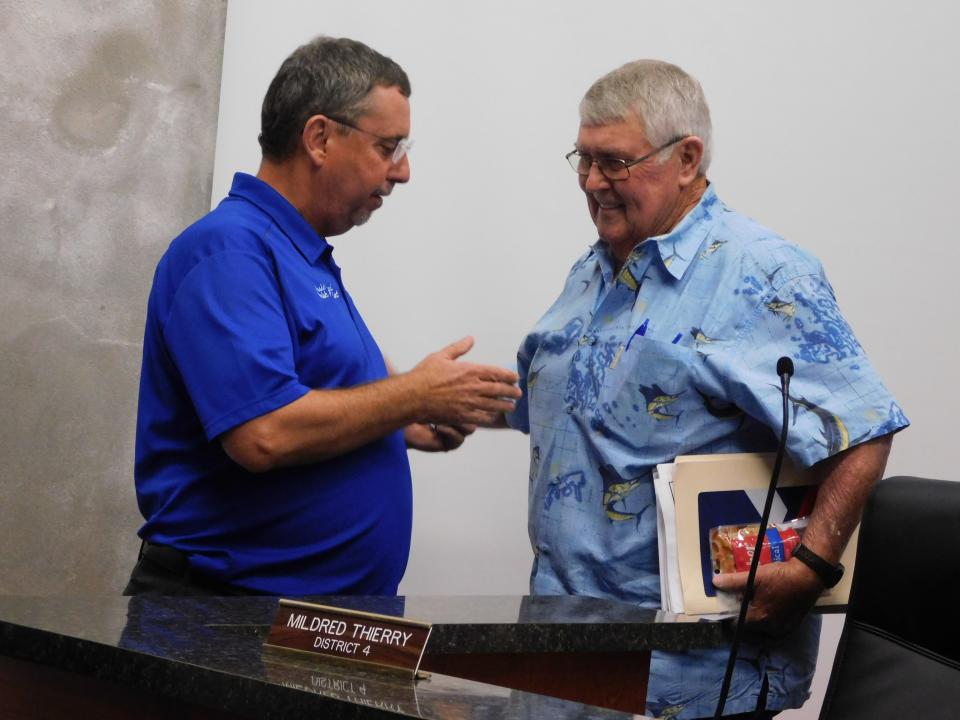 St. Landry Parish President Jessie Bellard, left, and Finance Chairman Wayne Ardoin discuss the proceedings after a meeting Wednesday night.