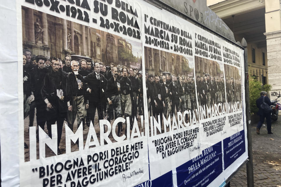 Posters commemorating the 100th anniversary of the March on Rome bearing a picture of Italian Fascist Dictator Benito Mussolini reading: "Marching!" with a quote by Mussolini "you have to set yourself goals to have the courage to reach them" are posted on the Rome's public billboard space, Thursday, Oct. 27, 2022. (AP Photo/Gregorio Borgia)