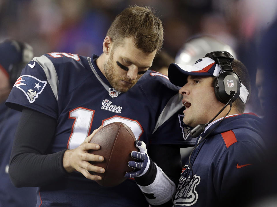 FILE - In this Nov. 3, 2013, file photo, New England Patriots offensive coordinator Josh McDaniels, right, talks to quarterback Tom Brady during the fourth quarter of an NFL football game against the Pittsburgh Steelers in Foxborough, Mass. No name stirs up quite as much angst and anger around Denver as McDaniels. The former Broncos coach, now offensive coordinator for the Patriots, left havoc in the wake of his two-year stint in Denver, and has a chance to leave another scar when the Patriots meet the Broncos in the AFC championship game on Sunday. (AP Photo/Steven Senne, File)