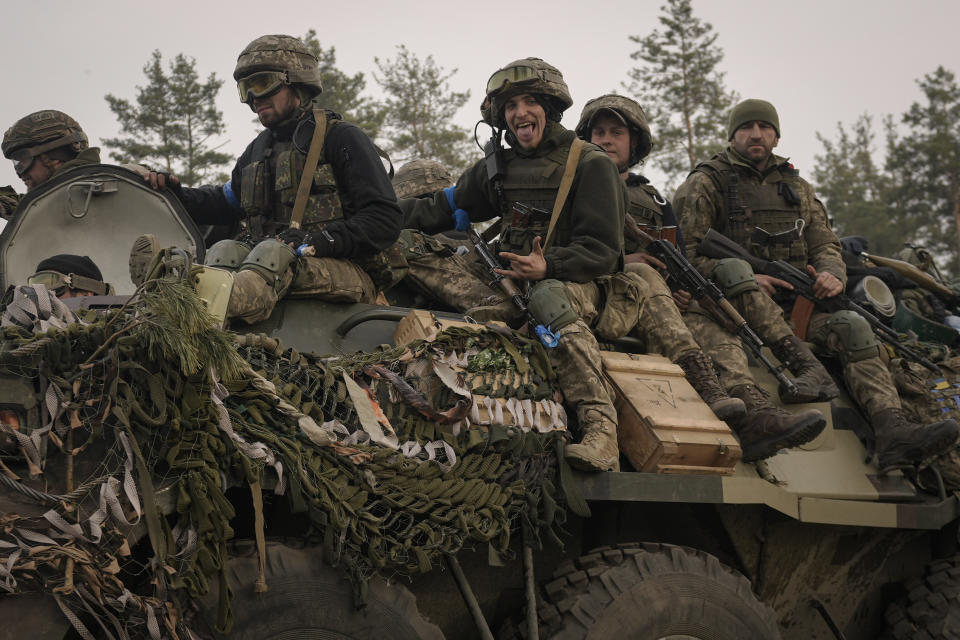 Ukrainian servicemen ride on an armored transporter driving through a Russian position overran by Ukrainian forces outside Kyiv, Ukraine, Thursday, March 31, 2022. Heavy fighting raged on the outskirts of Kyiv and other zones Thursday amid indications the Kremlin is using talk of de-escalation as cover while regrouping and resupplying its forces and redeploying them for a stepped-up offensive in eastern Ukraine. (AP Photo/Vadim Ghirda)