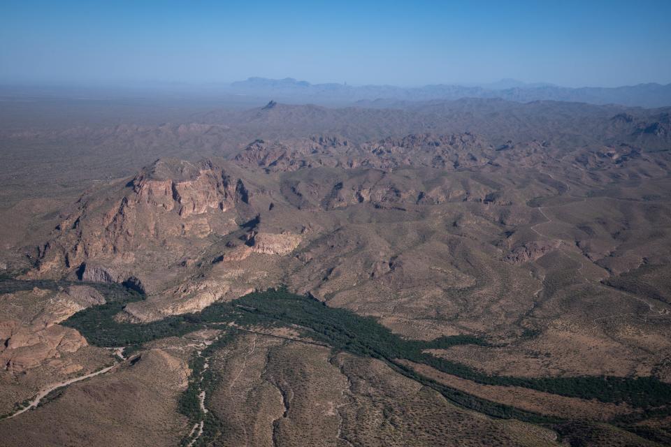 A green strip of vegetation marks the path of the Gila River, as it winds past Kearny, May 12, 2023.
