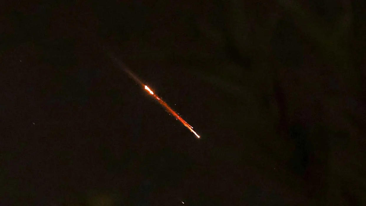 Objects are seen in the sky above Jerusalem after Iran launched drones and missiles toward Israel on April 14, 2024.