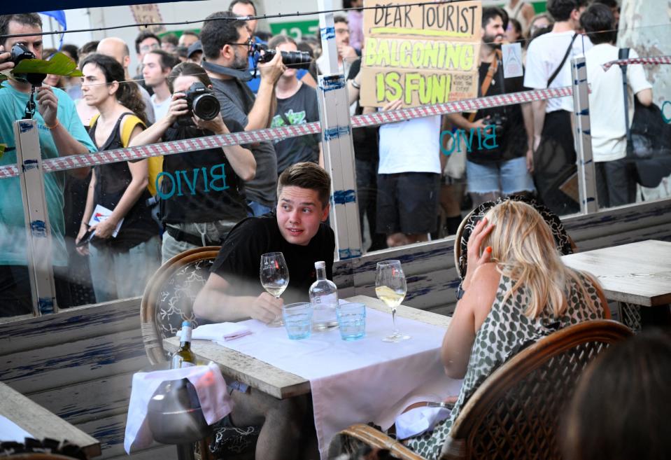 Diners in Barcelona sit amid protests against overtourism on July 6, 2024.