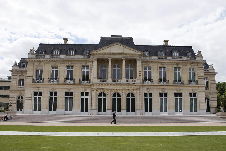 FILE - In this June 7, 2017 file photo, the Organisation for Economic Co-operation and Development (OECD) headquarters is pictured in Paris, France. Some 130 countries have backed a global minimum tax as part of a worldwide effort to keep multinational firms from dodging taxes by shifting their profits to countries with low rates. The agreement announced by the Organization for Economic Cooperation and Development Thursday also provides for taxing the largest global companies in countries where they earn profits through online businesses but may have no physical presence.(AP Photo/Francois Mori, File)