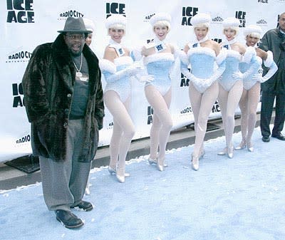 Cedric The Entertainer thinks about entertaining some Rockettes at the Radio City Music Hall premiere of Ice Age