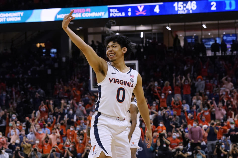 FILE - Virginia guard Kihei Clark (0) celebrates a 3-point shot during the first half of the team's NCAA college basketball game against Duke on Feb. 23, 2022, in Charlottesville, Va. The Cavaliers start the season ranked 18th and received the second-most first place votes in Atlantic Coast Conference preseason prognostications by the media, thanks in large part to the returns of fifth-year leader and point guard Clark and bruising forward Jayden Gardner, their leader in scoring and rebounding. (AP Photo/Steve Helber, File)