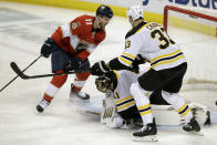 Boston Bruins goaltender Jaroslav Halak (41) makes a save as Florida Panthers left wing Jonathan Huberdeau (11) and defenseman Zdeno Chara (33) look on during the second period of an NHL hockey game, Thursday, March 5, 2020, in Sunrise, Fla. (AP Photo/Wilfredo Lee)