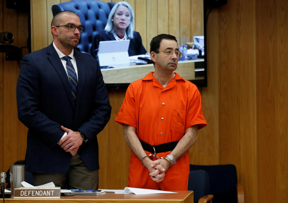 Larry Nassar stands with his attorney Matt Newburg as Judge Janice Cunningham (seen on screen) gives instructions during Nassar's second sentencing in the Eaton County Circuit Court in Charlotte, Michigan, U.S., January 31, 2018.&nbsp; (Photo: Rebecca Cook / Reuters)