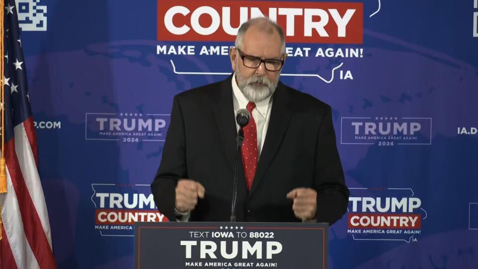 Barney Bornhoft, a pastor, prayed at the beginning of an Ankeny, Iowa, rally in December for “a hedge of protection” around Trump. (NBC News)