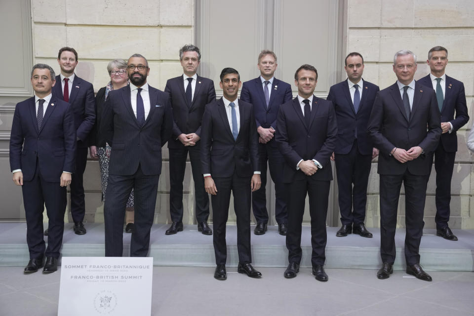 French President Emmanuel Macron, centre right, and Britain's Prime Minister Rishi Sunak, centre, pose with ministers during a French-British summit at the Elysee Palace in Paris, Friday, March 10, 2023. French President Emmanuel Macron and British Prime Minister Rishi Sunak meet for a summit aimed at mending relations following post-Brexit tensions, as well as improving military and business ties and toughening efforts against Channel migrant crossings. (AP Photo/Kin Cheung, Pool)
