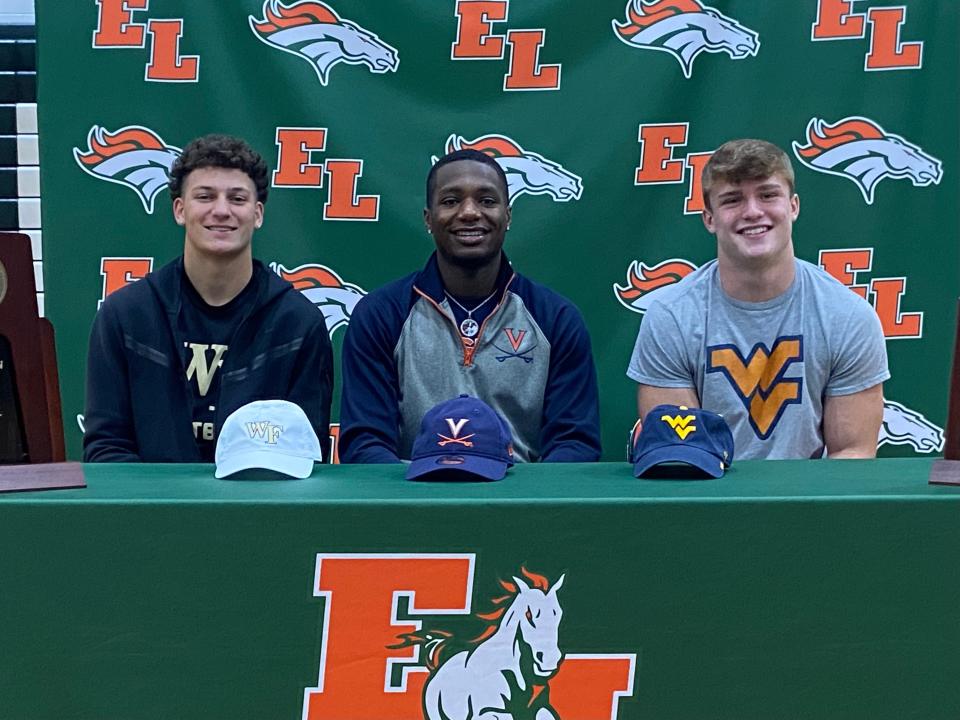 East Lincoln football standouts (from left) Tyler Mizzell, Keandre Walker and Ben Cutter are all smiles after signing with Wake Forest, Virginia and West Virginia., respectively.