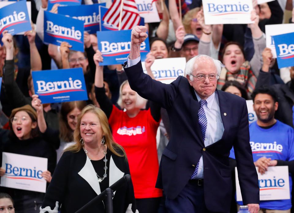 Democratic presidential candidate Bernie Sanders and his wife, Jane O'Meara Sanders, celebrate in Manchester, N.H., on Feb. 11.