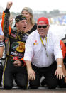 FILE - Jamie McMurray, left, and car owner Chip Ganassi celebrate on the start-finish line after McMurray won the NASCAR Brickyard 400 auto race at Indianapolis Motor Speedway in Indianapolis, in this Sunday, July 25, 2010, file photo. Chip Ganassi has sold his NASCAR team to Justin Marks, owner of Trackhouse Racing, and will pull out of the nation's top stock car series at the end of this season. Ganassi fields two cars in the Cup Series but will transfer his North Carolina race shop and all its assets to Marks for 2022. “He made me a great offer that required my attention,” Ganassi told The Associated Press on Wednesday, June 30, 3031, as the sale was announced. (AP Photo/Tom Strickland, File)