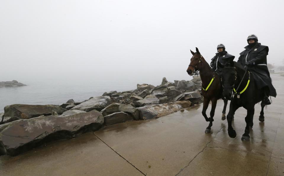 Members of the Cleveland Police Mounted Unit ride the Lake Erie shoreline, Tuesday, Jan. 3, 2017, in Cleveland. Cleveland officials say the search for a plane carrying six people that disappeared last week over Lake Erie has resumed. Tuesday marks the third straight day that conditions have allowed recovery teams to search the lake for a Columbus-bound Cessna 525 Citation that vanished from radar shortly after takeoff Thursday night from Burke Lakefront Airport. (AP Photo/Tony Dejak)