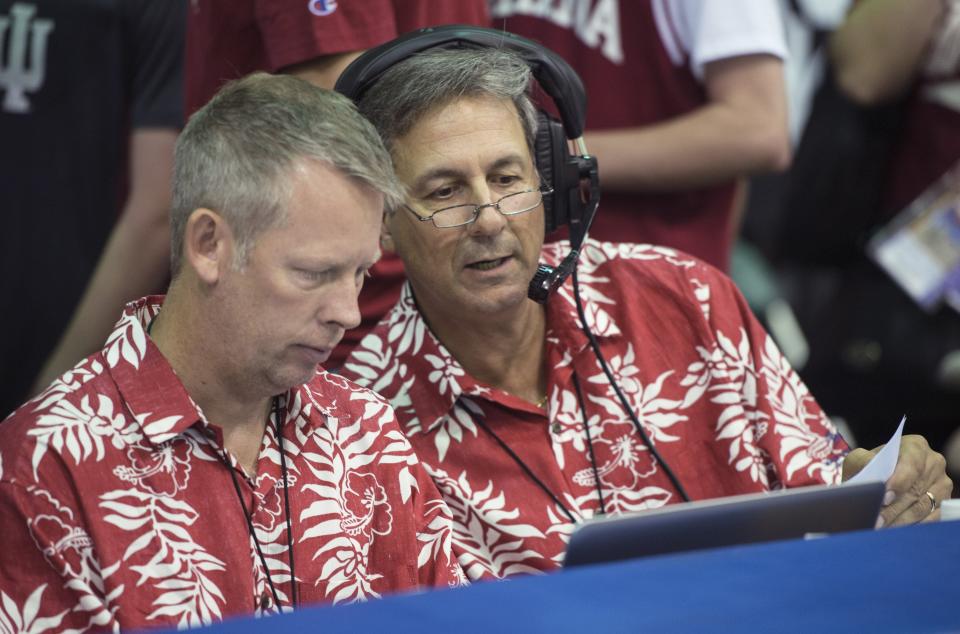 John Decker, left, and Mick Renneisen, both of Bloomington, go over the final statistics from one of the four games they worked Monday, the first day of the Maui Invitational Tournament in Lahaina, Hawaii.