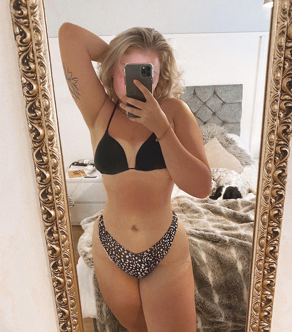 Woman in a bikini taking a selfie in the mirror