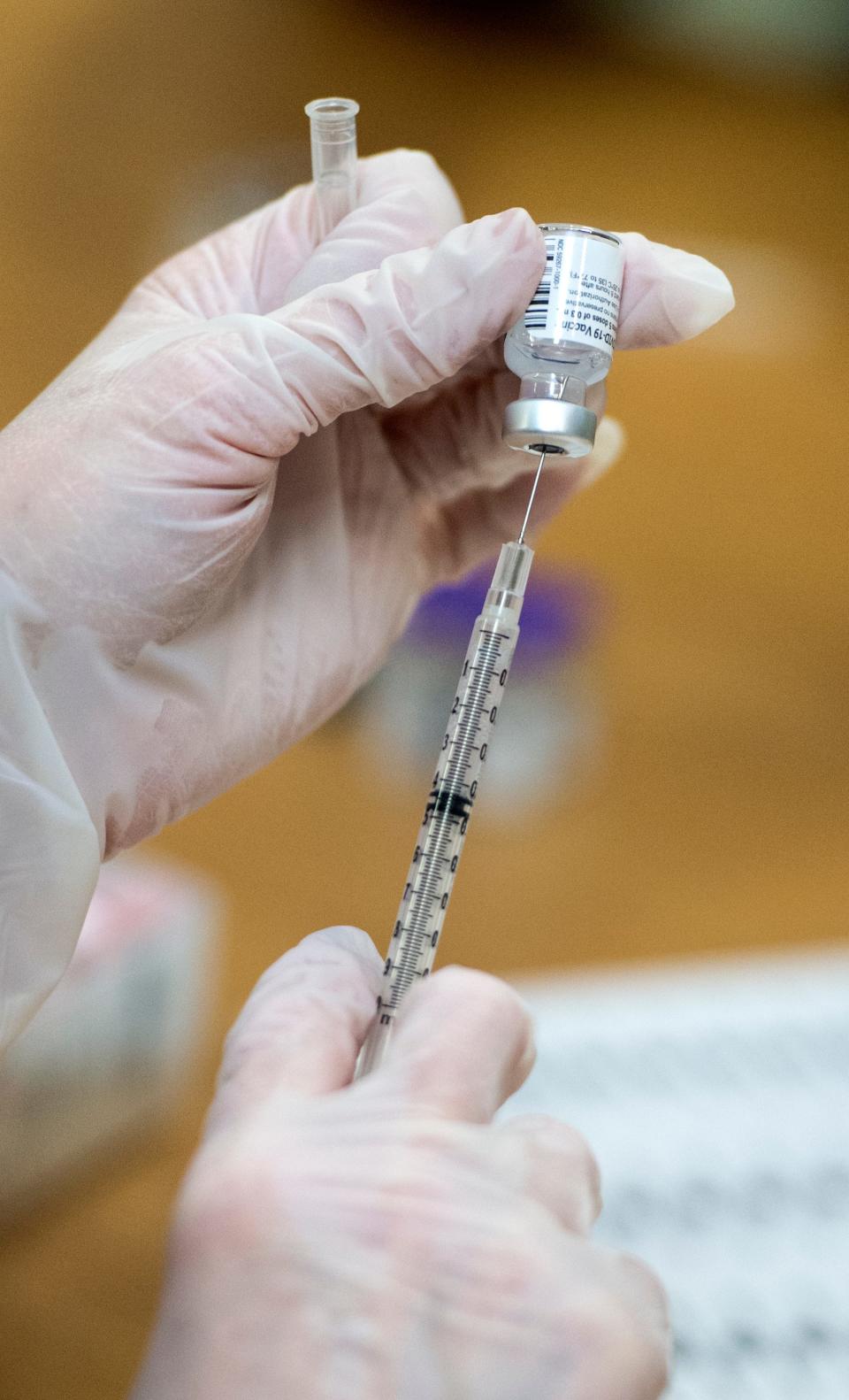 A dose of the Pfizer COVID-19 vaccine is loaded into a syringe at University Hospital in Augusta on Dec. 22, 2020.