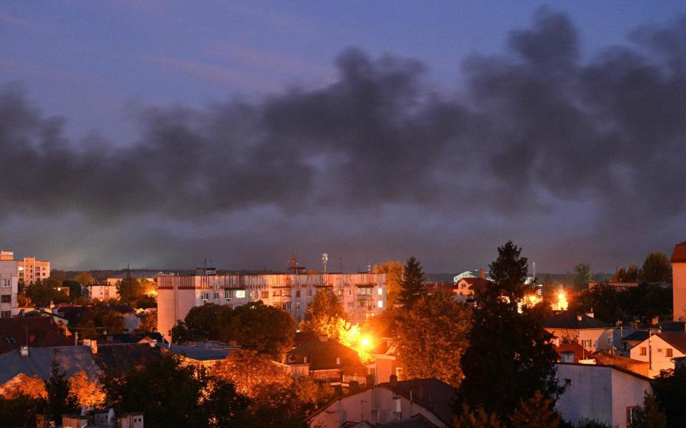Black smoke billows over the city after drone strikes in Lviv