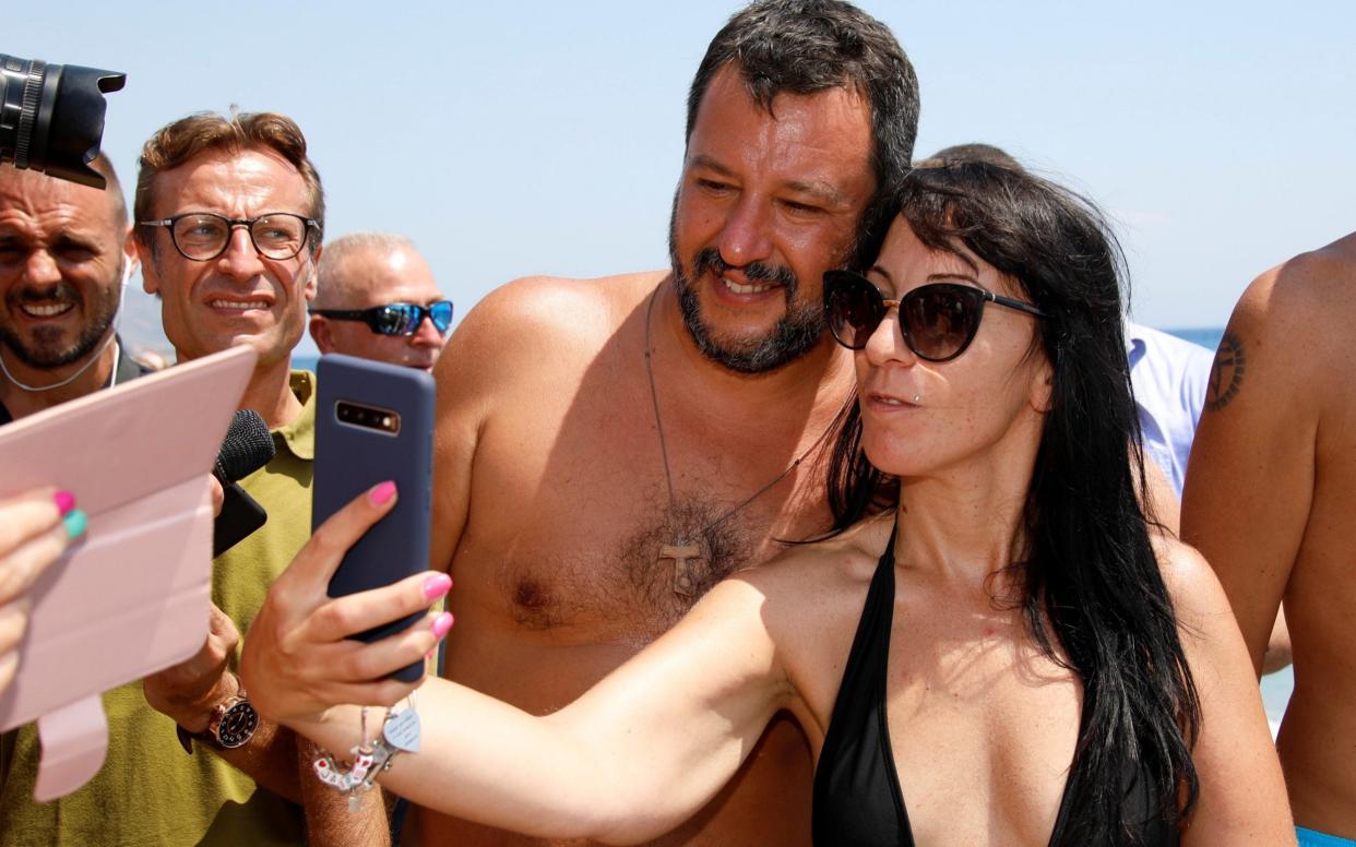 Leader of the League party Matteo Salvini poses for a selfie as he meets supporters at the Caparena beach in the Sicilian seaside town of Taormina - REUTERS