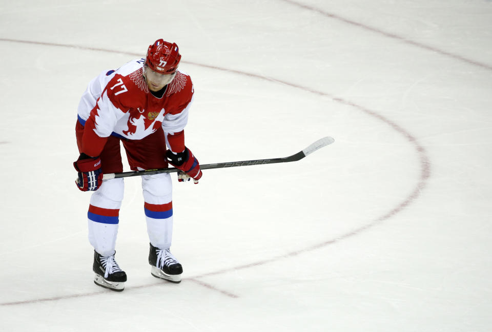 Russia defenseman Anton Belov reacts at the end of a men's quarterfinal ice hockey game against Russia at the 2014 Winter Olympics, Wednesday, Feb. 19, 2014, in Sochi, Russia. Finland won 3-1. (AP Photo/Mark Humphrey)